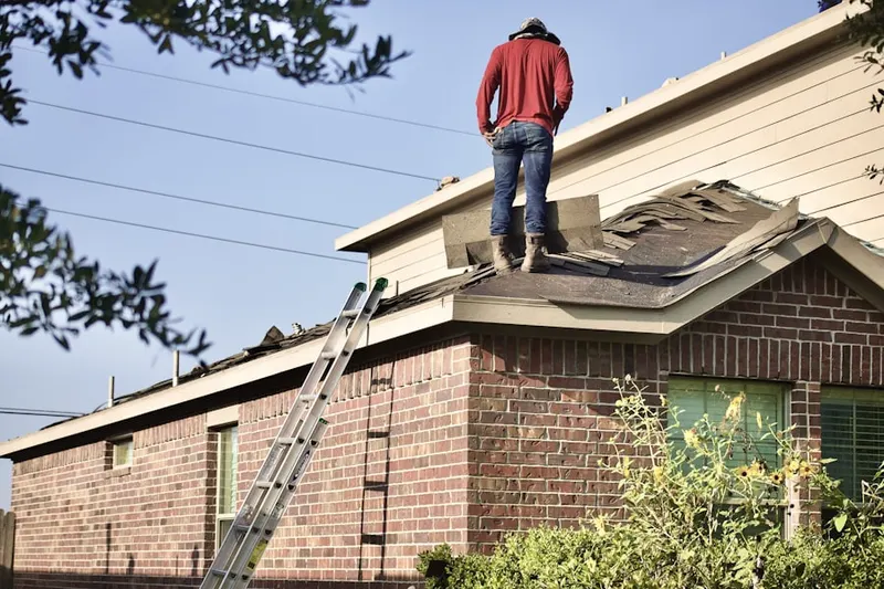 Professional roofer working on a residential roof in Wood Park